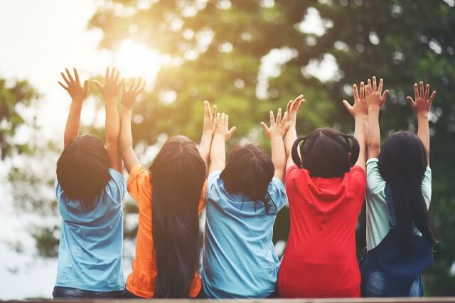 Children Day_group-kids-friends-arm-around-sitting-together